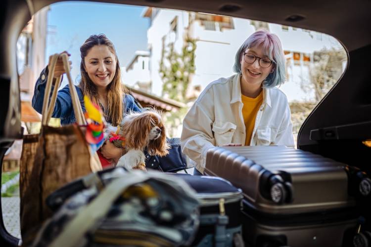 girls loading car for a vacation